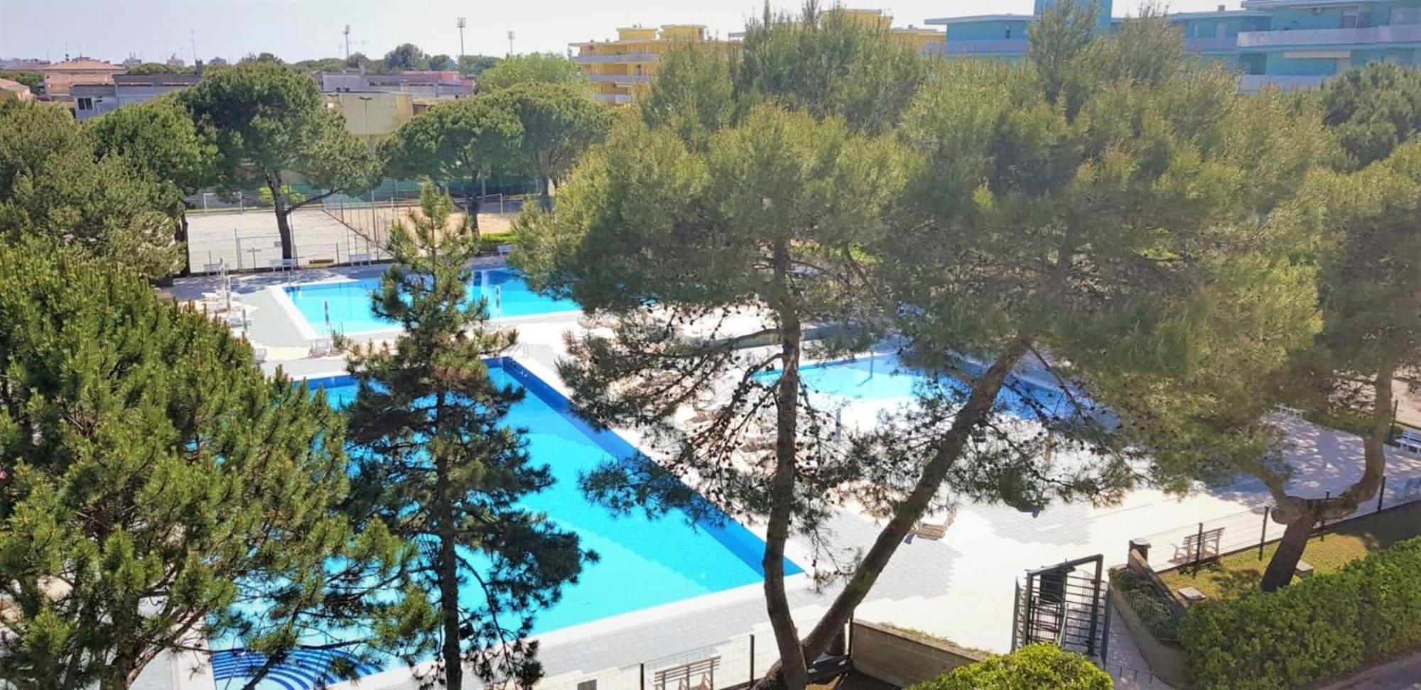 With Balcony In A With Pool Apartment